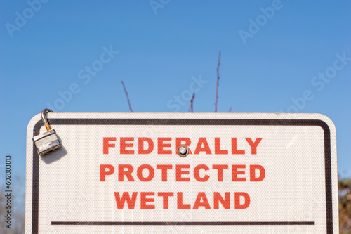 federally protected wetland sign in park photo