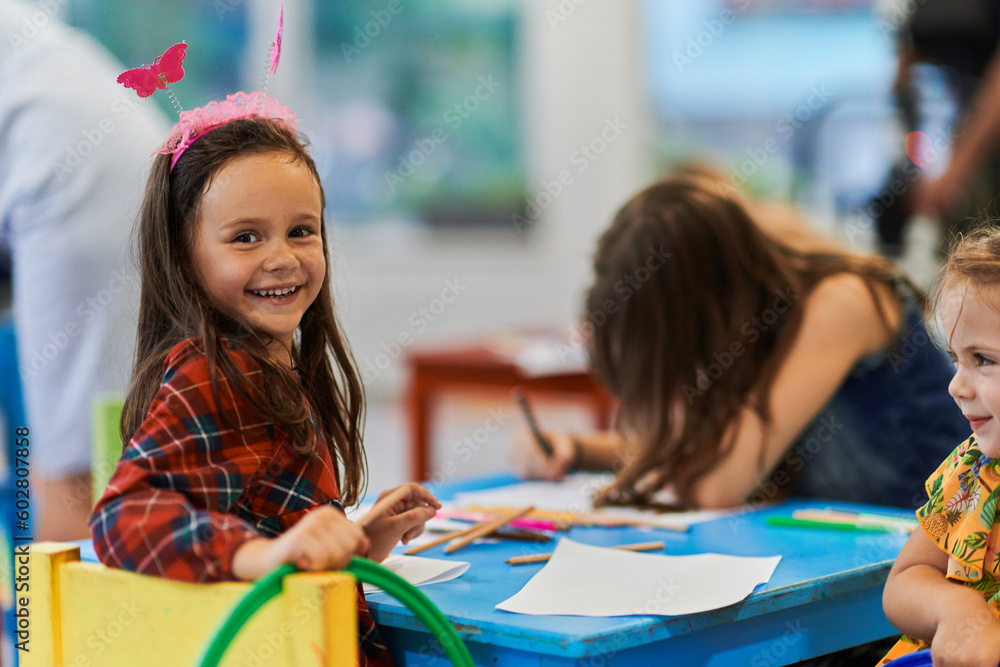 Creative kids during an art class in a daycare center or elementary school classroom drawing with female teacher. Creative kids during an art class in a daycare center or elementary school classroom drawing with female teacher.