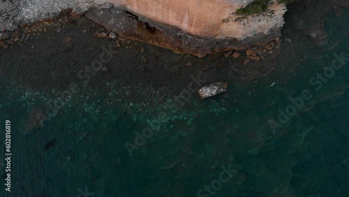 Rugged Shore Of Plaza Ricardova Glava Near OId Town Budva In Montenegro. aerial topdown photo