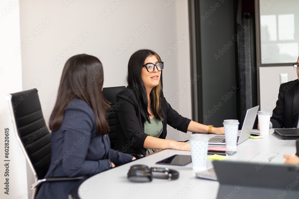 business women directing a conversation in the office, woman in a mixed coworking space, Happy coworkers meeting for new project planning in office. business women directing a conversation in the office, woman in a mixed coworking space, Happy coworkers meeting for new project planning in office.