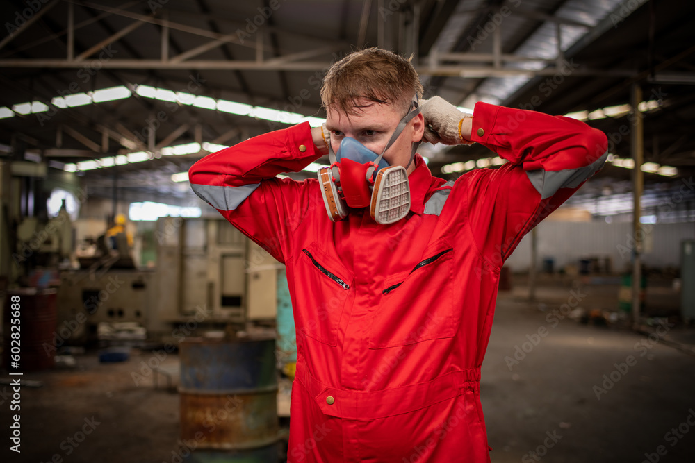 Fototapeta premium Portrait industry worker with safety uniform protective wearing gas mask to safe before start work to check chemical or gas in factory is industry safety concept.