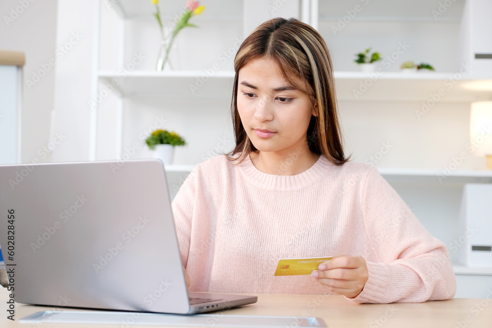 Young asian woman make payment online shopping by credit card Young asian woman make payment online shopping by credit card