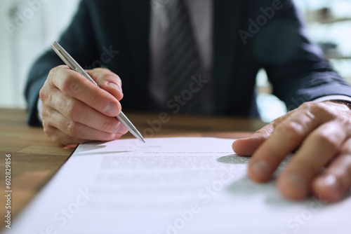 Slika na platnu Male worker puts personal signature on contract paper sheet