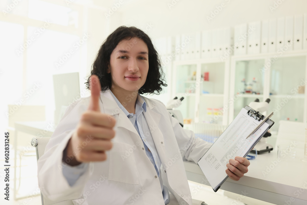 Satisfied scientist shows thumb up gesture looking in camera Satisfied scientist shows thumb up gesture looking in camera