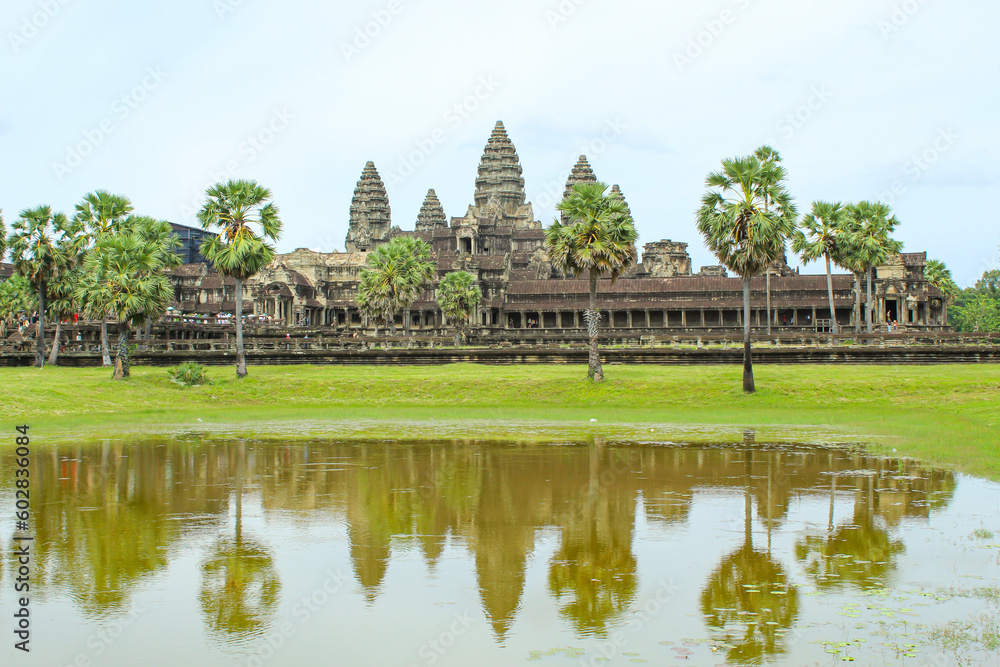 Scenery of Angkor Wat across the lake and the reflection in the water during thw cloudy sunrise. UNESCO world heritage site in Cambodia Scenery of Angkor Wat across the lake and the reflection in the water during thw cloudy sunrise. UNESCO world heritage site in Cambodia