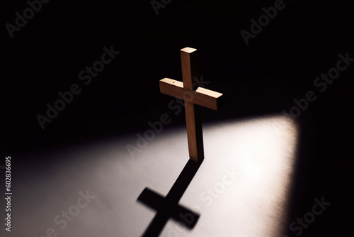 cross, wooden cross illuminated by a small light in the dark