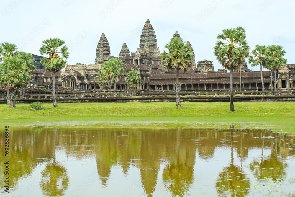 Angkor Wat temple reflecting in water of Lotus pond. Siem Reap. Cambodia. Panorama, copy space for text Angkor Wat temple reflecting in water of Lotus pond. Siem Reap. Cambodia. Panorama, copy space for text
