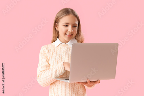 Little girl using laptop on...