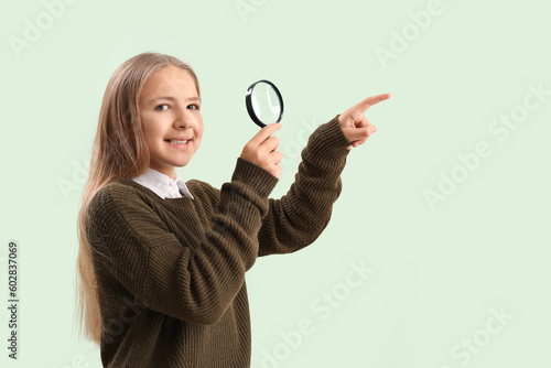 Little girl with magnifier ...