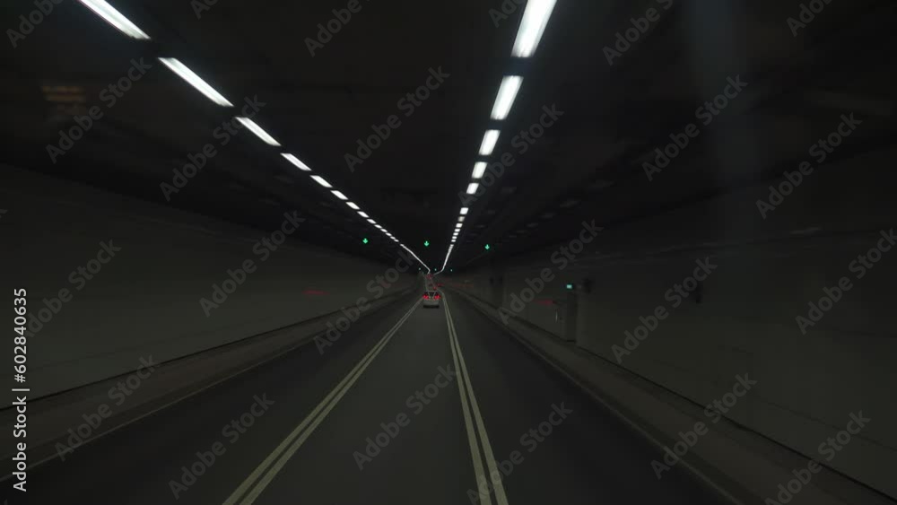 Vehicles driving through the shuttle tunnel in downtown Hong Kong at night Vehicles driving through the shuttle tunnel in downtown Hong Kong at night