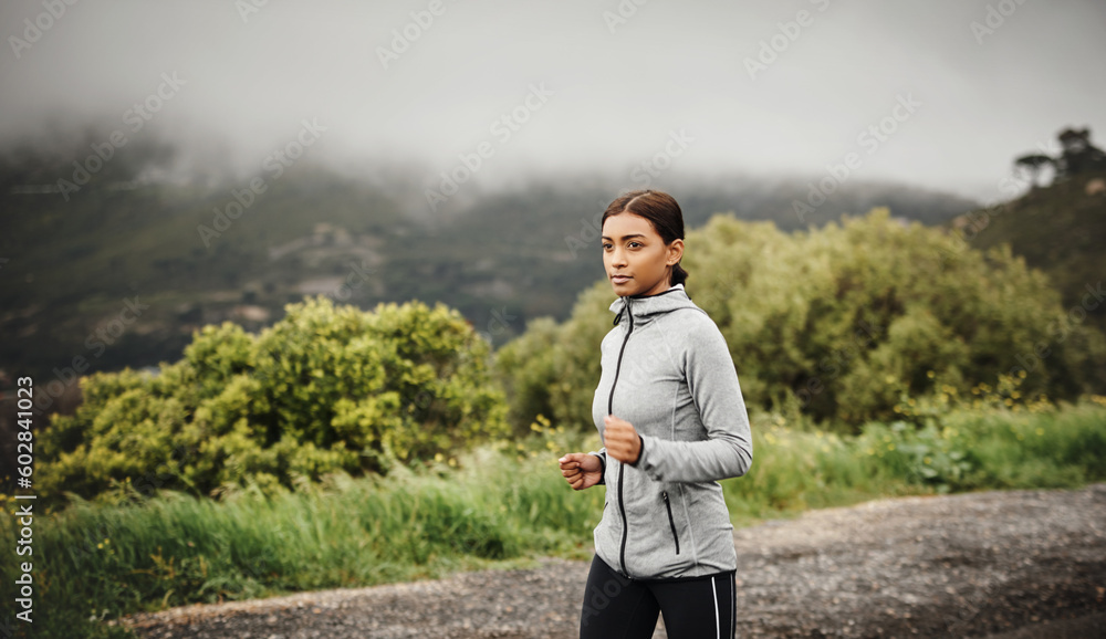 Nature, running and Indian woman training, cardio or workout goal with progress, energy or fitness. Female person, athlete or runner outdoor, mountain view or focus with exercise, sports or wellness