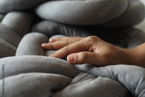  hand on gray color pillow 