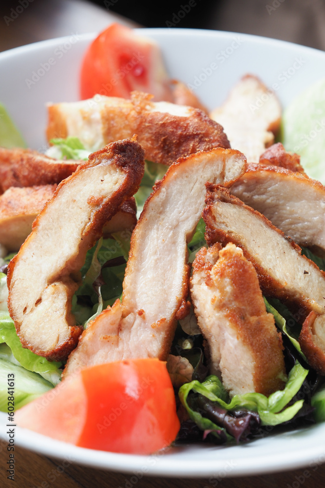 Grilled chicken and fresh vegetable salad on table. Grilled chicken and fresh vegetable salad on table.