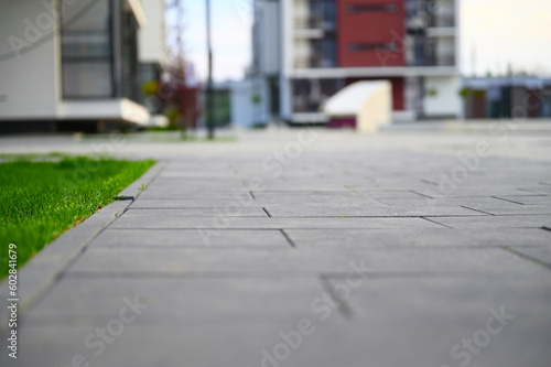 Wallpaper Mural A green lawn stretches out before tall, modern urban houses, offering a serene contrast to the bustling cityscape. Torontodigital.ca