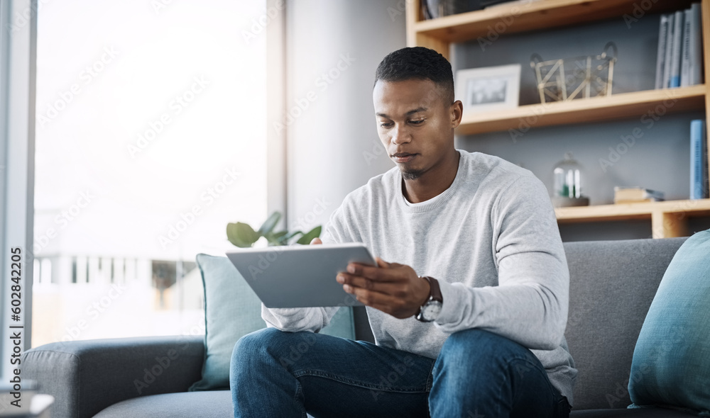Relax, tablet and man on sofa, internet scroll and reading social media post, email or streaming video on subscription. Mobile app, info and online connection, person surfing movie website on couch.