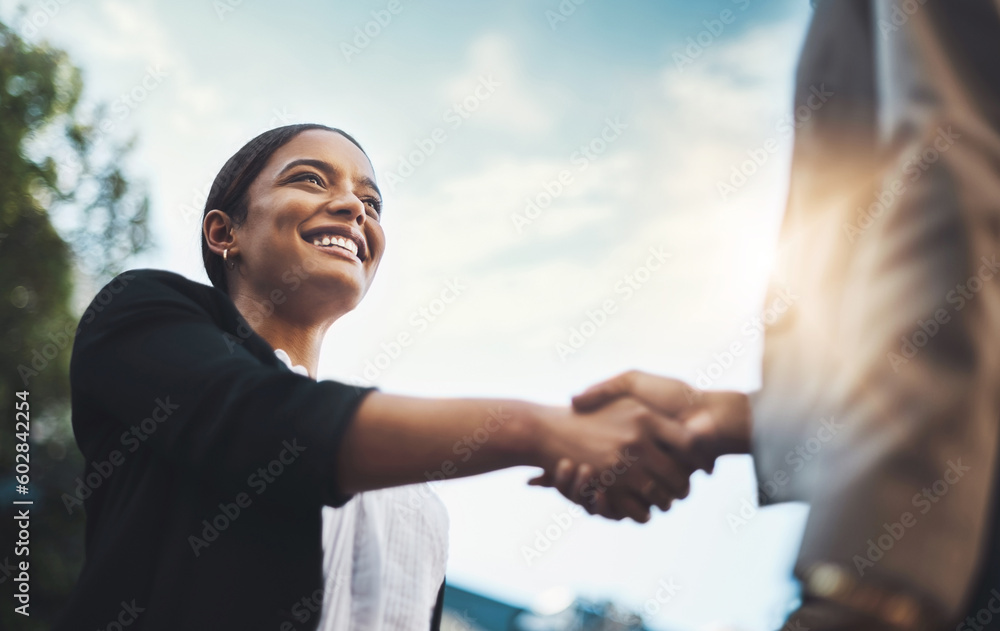 © Donson/peopleimages.com - Business people, handshake and meeting in city for partnership, greeting or introduction and welcome outdoors. Happy woman with smile shaking hands for b2b, collaboration or agreement in deal outside