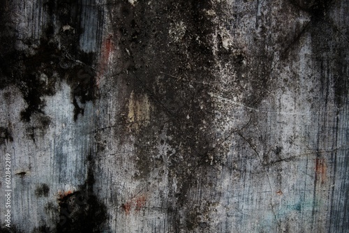 This close-up of a weathered, rundown wall displays the deterioration of its textured pattern and reveals an old architecture in decline.