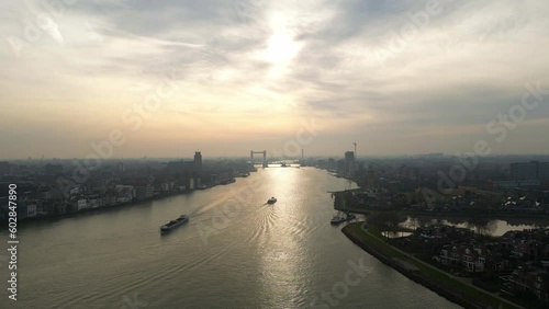Wallpaper Mural Colorful sunset over the skyline of the city Dordrecht while two vessels are sailing on the river. Drone panning shot Torontodigital.ca