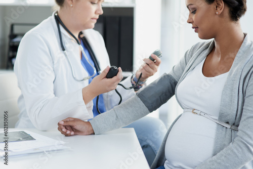 Blood pressure, gynecology and doctor with a pregnant woman for a consultation of health. Hospital, wellness check and a medical worker with a patient consulting about hypertension during pregnancy