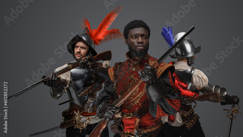 Shot of three conquistadors from past armed with flintlock rifles.