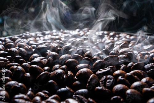 Coffee beans roasting with smoke,  selective focus, and soft focus.