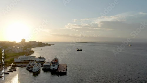 Aerial view passing river boats docked on the coast of Santarem, sunset in Brazil photo