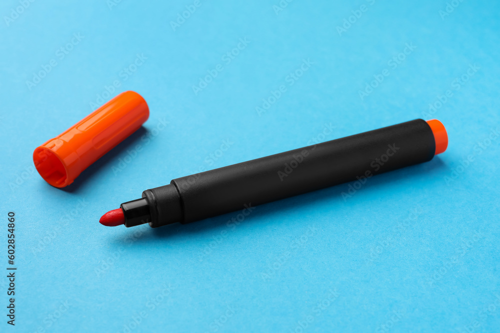 Bright orange marker on light blue background Bright orange marker on light blue background