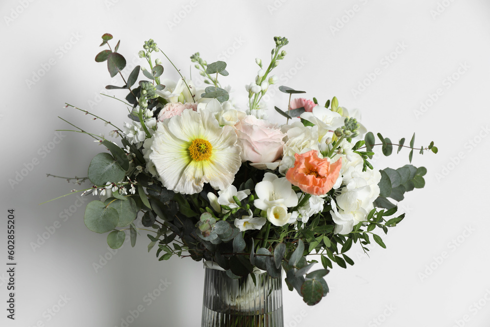 Bouquet of beautiful flowers in vase on white background, closeup