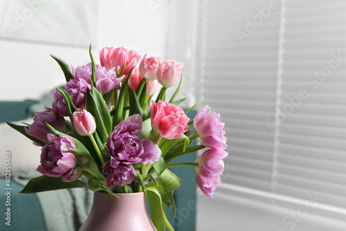 Beautiful bouquet of colorful tulip flowers indoors. Space for text