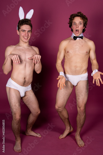 Easter. Two young attractive guys dressed as rabbits. Happy couple.