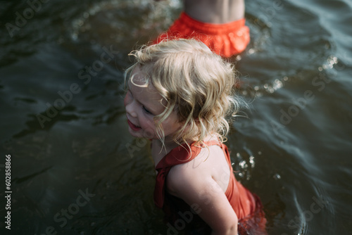 Kids swimming in lake during summer