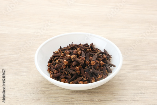 Dried cloves (cengkeh), dried herbs served in small bowl 