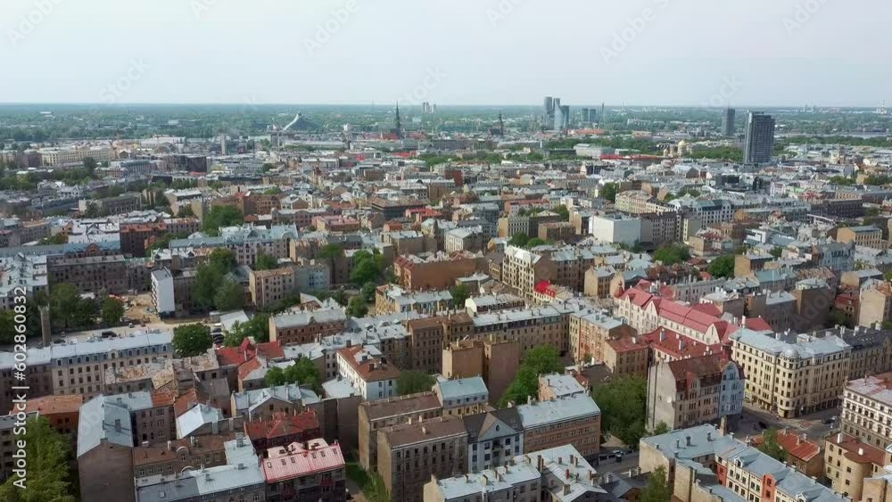 Riga Cityscape Spring Aerial Top View Video, Town, Latvia. Sunny Day Building Rooftops. Riga Skyline, Latvia, City Center, Teika, Purvciems in the Background. Architecture of the Downtown. Riga Cityscape Spring Aerial Top View Video, Town, Latvia. Sunny Day Building Rooftops. Riga Skyline, Latvia, City Center, Teika, Purvciems in the Background. Architecture of the Downtown.
