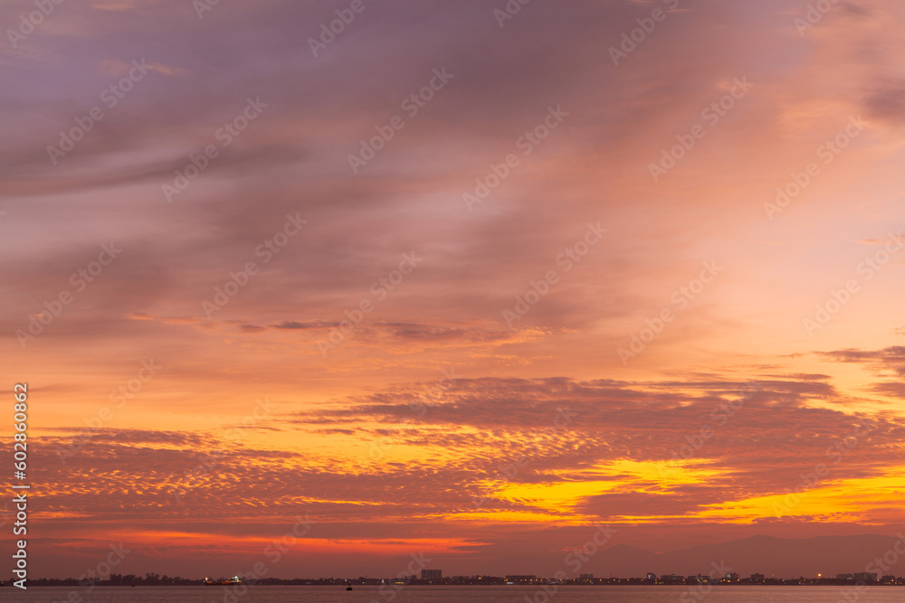 Colourful sunset sky. Full frame view of wispy colourful clouds up in the sky during sunrise or sunset hour. Sky replacement asset.