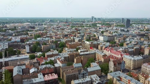 Riga Cityscape Spring Aerial Top View Video, Town, Latvia. Sunny Day Building Rooftops. Riga Skyline, Latvia, City Center, Teika, Purvciems in the Background. Architecture of the Downtown. photo