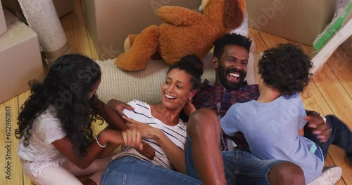 Playful, happy and surprise with family in living room for affectionate, bonding and game. Happiness, funny and tickle with parents and children playing at home for weekend, excited and love