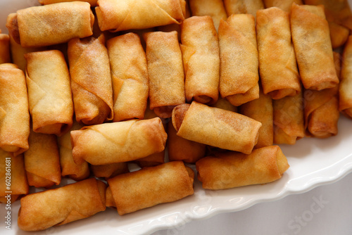 Εκτύπωση καμβά A top down view of a catered platter of mini egg rolls.