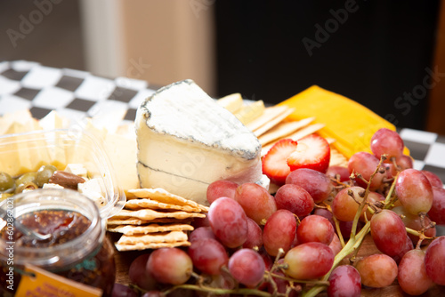 A view of an assorted cheese board, featuring a chunk of brie.