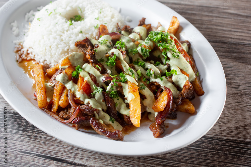 A view of a plate of lomo saltado. A view of a plate of lomo saltado.