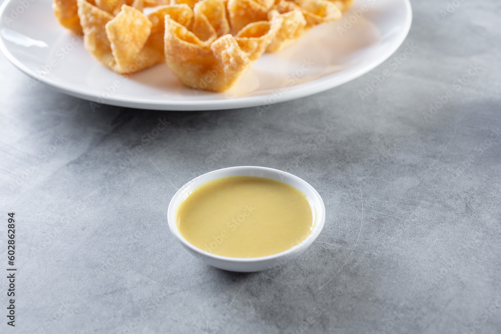 A view of a condiment cup of Chinese hot mustard. A view of a condiment cup of Chinese hot mustard.