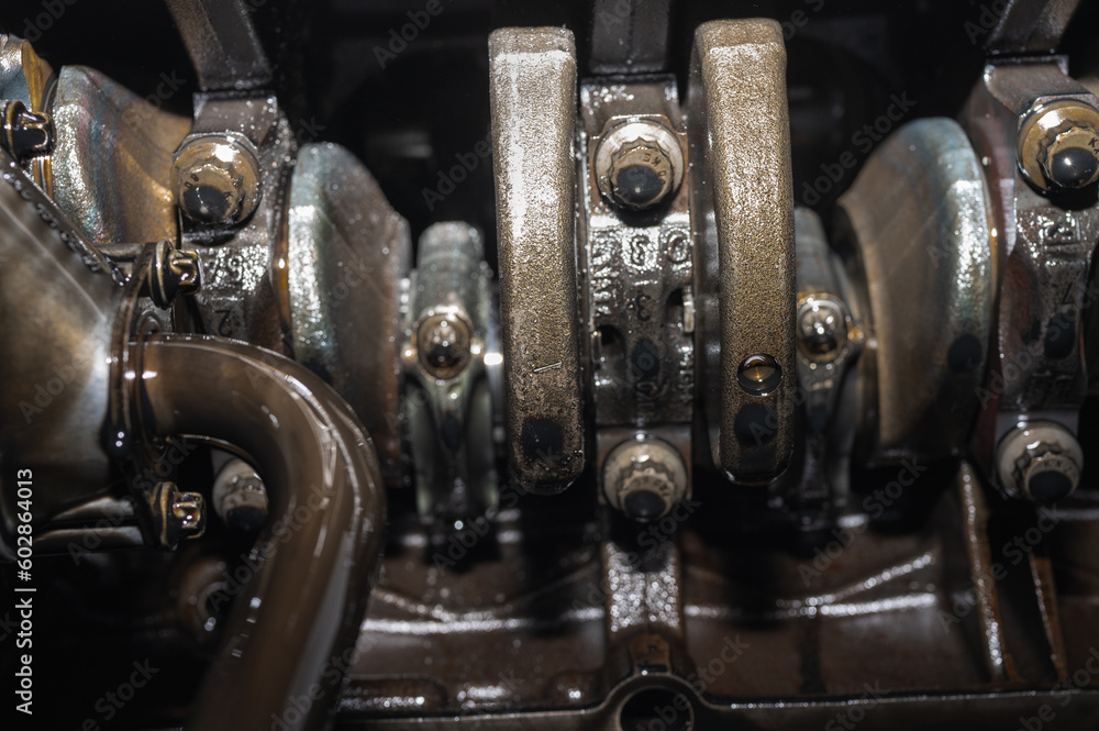 Close-up of a disassembled, engine, part of the automatic transmission box of a car on a machine in a garage or repair factory station for repair or maintenance. Detail. Close up view