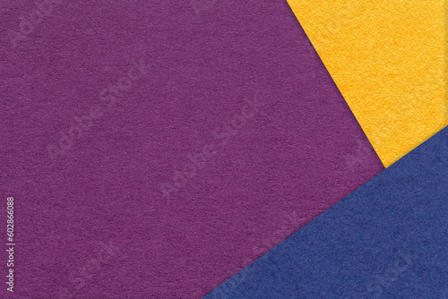 Texture of craft violet color paper background with yellow and blue border. Vintage abstract purple cardboard.