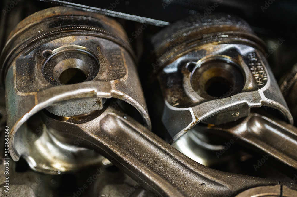 Close-up of a disassembled engine, parts of a car automatic transmission box on a car in a garage or repair shop station for repair or maintenance. Detail, spare parts, disassembly Close-up of a disassembled engine, parts of a car automatic transmission box on a car in a garage or repair shop station for repair or maintenance. Detail, spare parts, disassembly