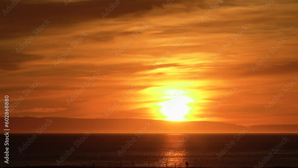 Cloudy orange sunset over mountains and ocean at Iceland, static Cloudy orange sunset over mountains and ocean at Iceland, static