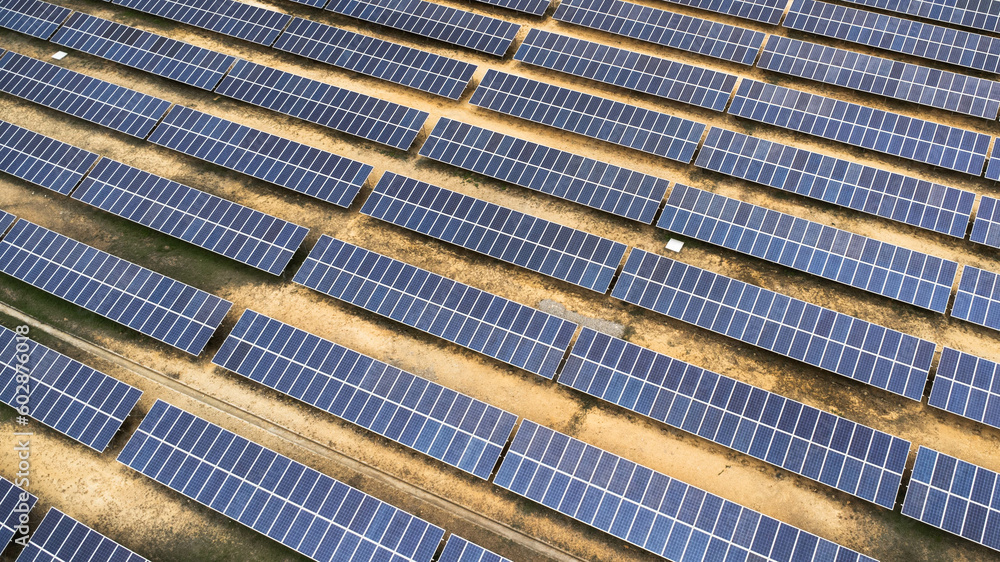 Obraz premium Top view on photovoltaic solar power panels. Drone aerial view of Solar panels system power generators from sun. Alternative Energy Sources - The Concept of Sustainable Resources.