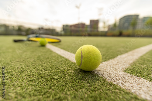 tennis racket with a tennis ball on a tennis court