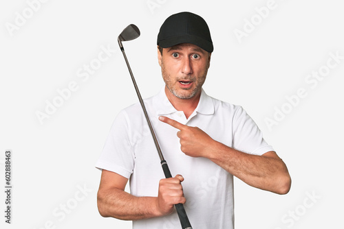 Middle aged golfer man pointing to the side