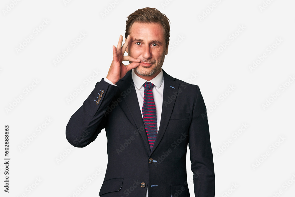 A middle-aged businessman isolated with fingers on lips keeping a secret. A middle-aged businessman isolated with fingers on lips keeping a secret.
