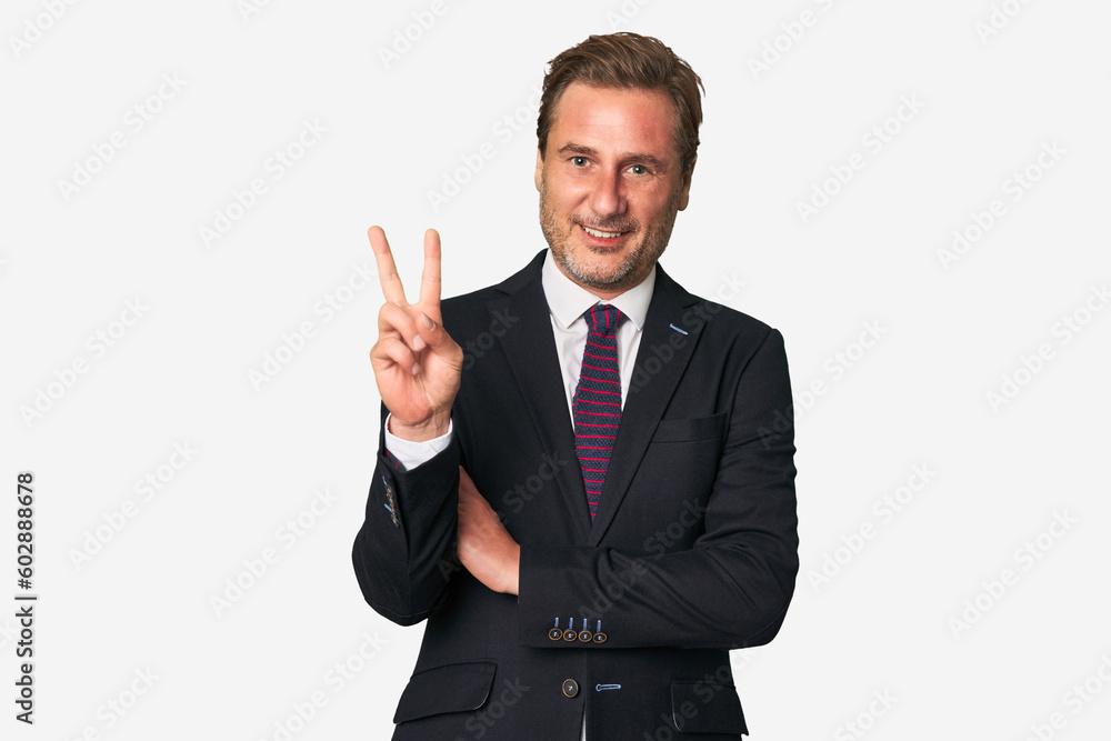 A middle-aged businessman isolated showing number two with fingers. A middle-aged businessman isolated showing number two with fingers.