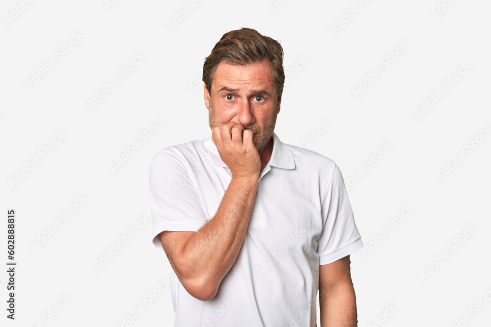 A middle-aged man isolated biting fingernails, nervous and very anxious. A middle-aged man isolated biting fingernails, nervous and very anxious.